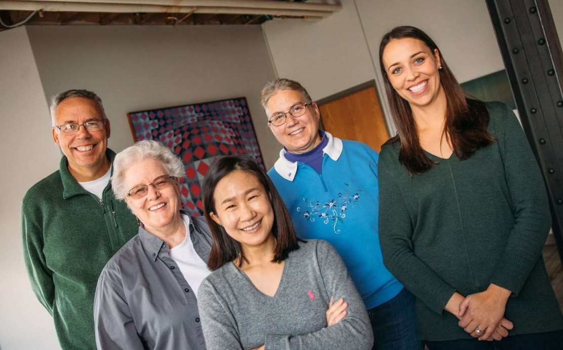 group of smiling people posing for the camera