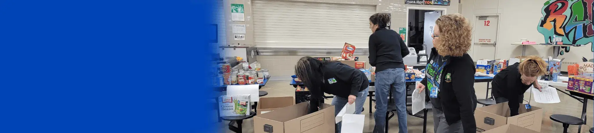 Photo of people pulling papers out of cardboard boxes